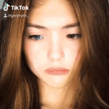 a close up of a girl 's face with a tiktok watermark on it