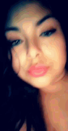 a close up of a woman 's face with a blurred background
