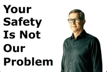 a man in a black shirt stands in front of a sign that says your safety is not our problem