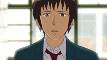 a man in a suit and tie is looking at the camera with a sad look on his face