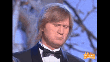 a man in a tuxedo with a bow tie and the words uralski пельмени on the bottom