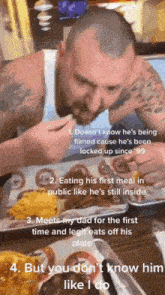 a man in a white tank top is eating a meal