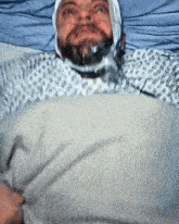 a man laying in a hospital bed with a bandage on his head