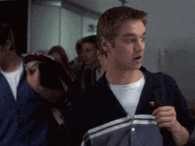a man with a surprised look on his face is wearing a striped shirt