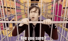 a man is behind bars in a store and says `` are you sure ? ''