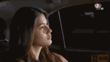 a woman is sitting in a car with a license plate that says 08 8106