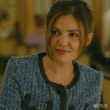 a woman in a blue sweater is asking what do you want