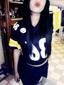 a girl is wearing a black jersey with the number 18 on it