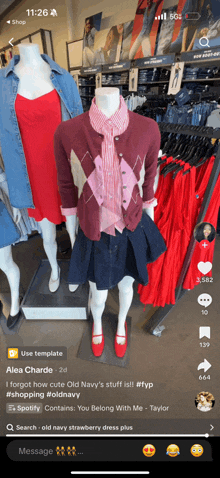 a phone screen shows a mannequin wearing a red dress and a cardigan