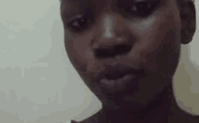 a close up of a woman 's face with her mouth open .