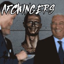 two men are standing next to a statue of a man with the words afcwinger 's written on it
