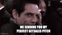 a man in a suit is making a funny face while talking on a cell phone .