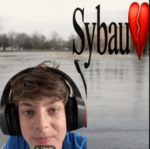 a boy wearing headphones with a broken heart in the background and sybau