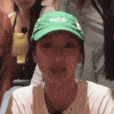 a woman wearing a green hat that says erka
