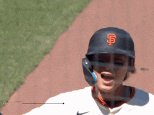 a baseball player wearing a helmet with the letter f on it