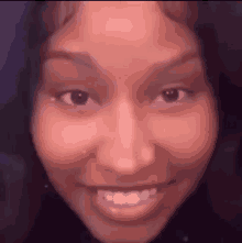 a close up of a woman 's face with a big smile on her face .