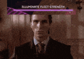 a man in a suit and tie stands in front of a screen that says " illuminate fleet strength "