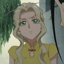 a girl with long blonde hair and green eyes is wearing a yellow shirt