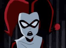 harley quinn from the batman animated series is wearing a jester hat and a scarf .
