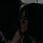 a close up of a woman 's face with tears coming out of her eyes