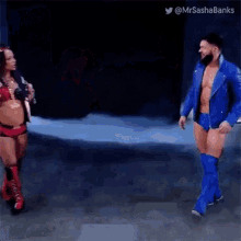 a man in a blue jacket is walking next to a woman in a red bikini ..