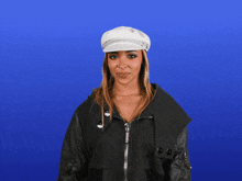 a woman wearing a white hat and black jacket