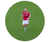 a soccer player wearing a red united jersey is running on the field