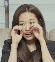 a woman with long brown hair is making a funny face