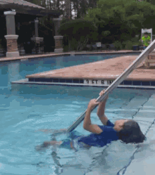 a person is swimming in a pool with a sign that says 9 ft a in