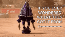 a man in a purple and black costume is dancing in front of a sign that says airtel