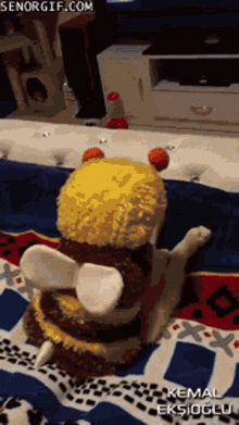 a cat wearing a bee costume is laying on a bed