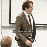 a man in a suit and tie is saying if you 're not in a classroom