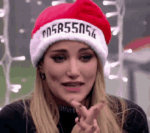 a woman wearing a santa hat that says 058555056