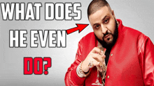 a man in a red jacket is holding a wine glass with the words " what does he even do " behind him