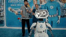a group of people standing in front of a disney poster
