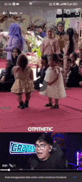 a screenshot of a video of a little girl dancing on a stage with the words otpticthetic on the bottom