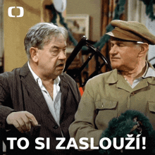two men standing next to each other with the words to si zaslouzi on the bottom right