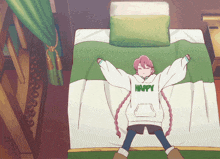 a girl is laying on a bed wearing a happy sweatshirt