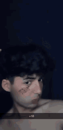 a close up of a man 's face with the number 18 visible