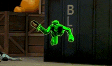a green cartoon character with a scarf around his neck is standing in front of a building .