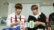 a group of young men are playing a game of cards and one of them is wearing a hoodie with the word vixx on it