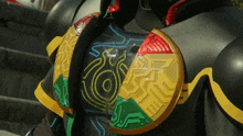 a close up of a person 's chest with a green yellow and red design
