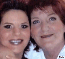 two women are standing next to each other and smiling for the camera .