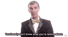 a man in a tuxedo and bow tie is talking about something .