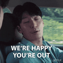 a man in a car says " we 're happy you 're out " in white letters