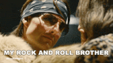 a man wearing glasses and a bandana says my rock and roll brother