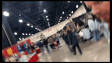 a blurred image of a convention hall with a sign that says no smoking