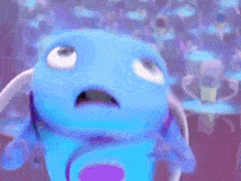 a close up of a blue fish with a surprised look on its face