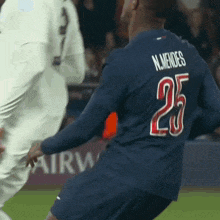 a soccer player with the number 25 on his back