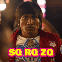 a man wearing a red jacket and a shirt that says sq rq zoq